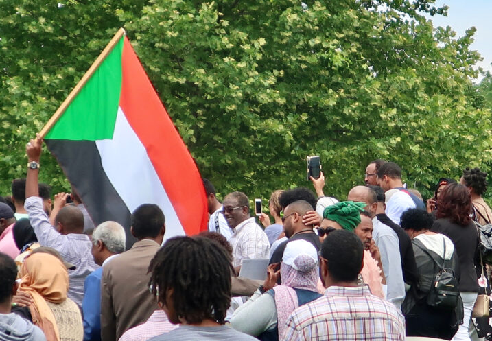 WASHINGTON, DC - JUNE 8, 2019: Demonstration in front of US Capitol Building calling for civilian rule in Sudan - man holds Sudan flag
